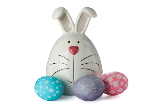 Decorated bunny and Easter eggs isolated on plain background. Festive tradition