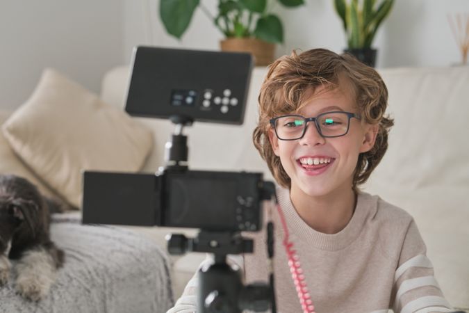 Preteen blogger shooting video for social media at home