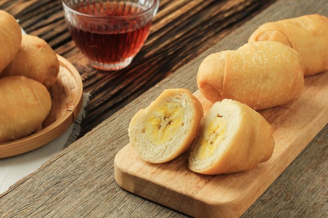 Plate of Indonesian banana dipped in flour snack served with tea