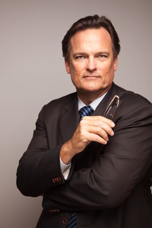 Professional Portrait of Serious Businessman on Grey Background
