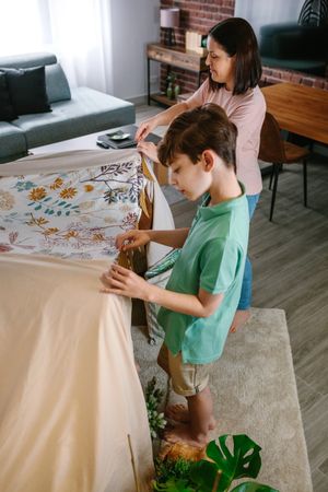 Mother and son preparing tent to camping at home