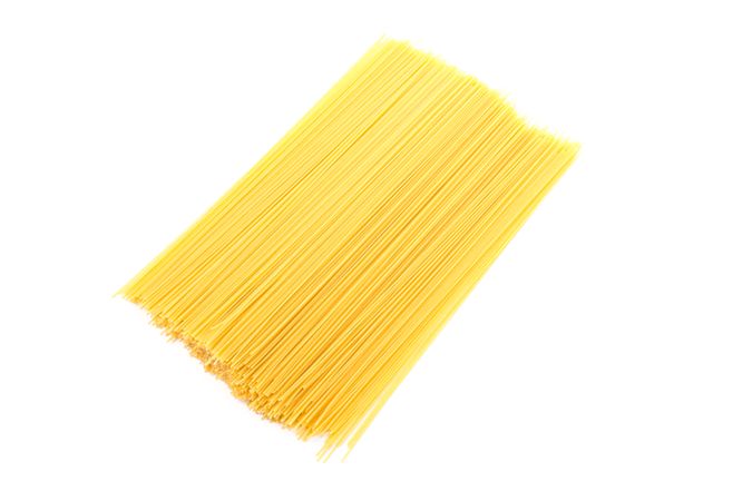 Pasta isolated on bright background, top view. Uncooked whole wheat pasta