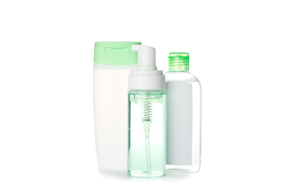 Shower gel, shampoo and scrud isolated on plain background