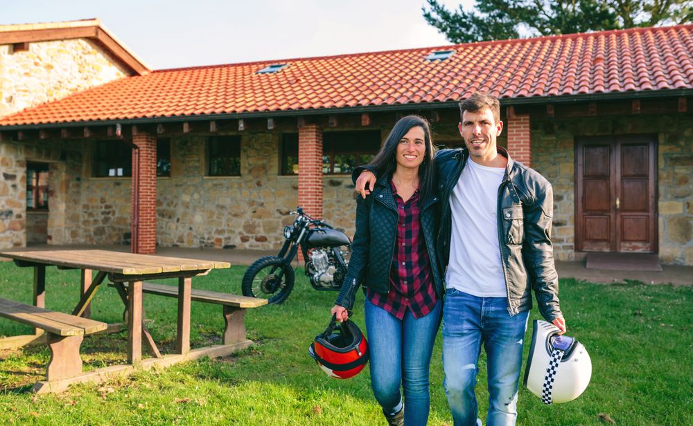 Couple walking embraced and custom motorcycle