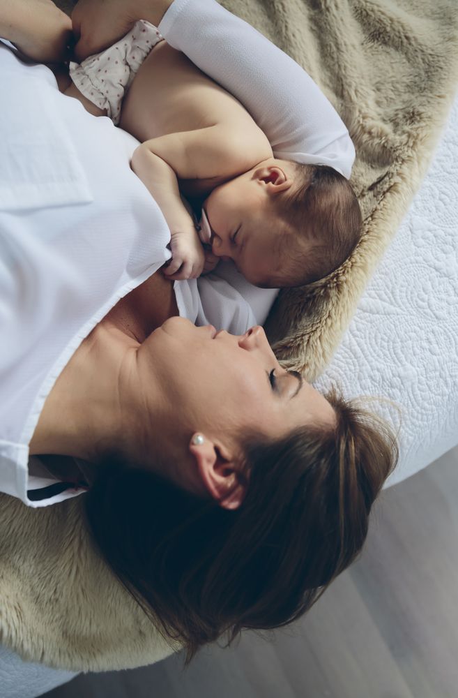 Mother hugging her newborn baby girl