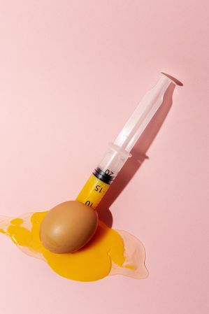 Syringe sucking yolk out of raw egg