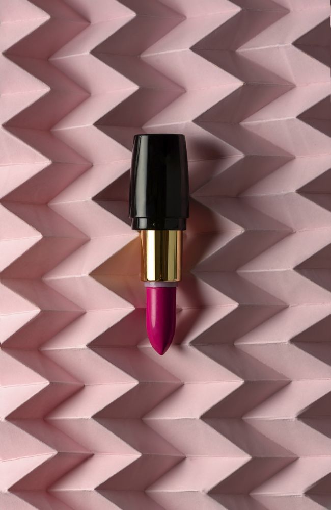 Lipstick on raised pink chevron. Product and make up concept