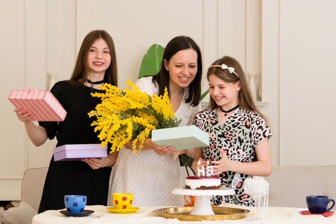 Woman and two girls celebrating birthday