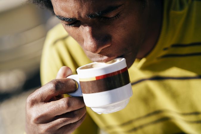 Man drinking coffee in the sun