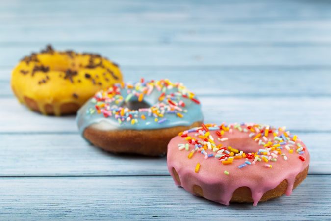 Delicious assorted colorful donuts on the table.