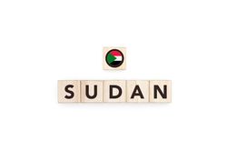 Wooden blocks bearing the name and flag of Sudan.