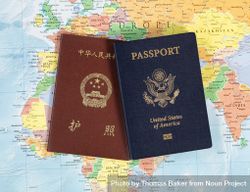 US and Chinese passport books on map 0V2ZX0