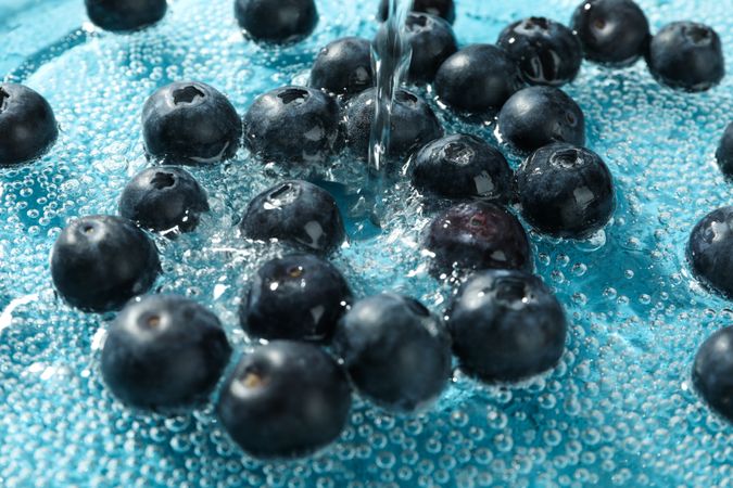 Blueberries being washed in clear water