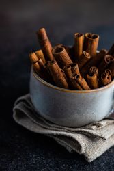 Side view of cinnamon sticks in mug