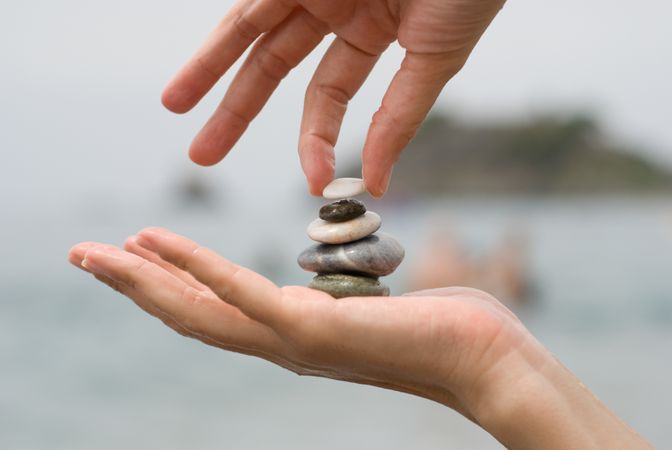 Person holding pile of small rocks