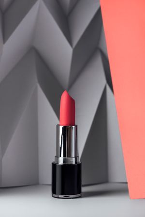 Pink lipstick on raised chevron. Product and make up contemporary concept
