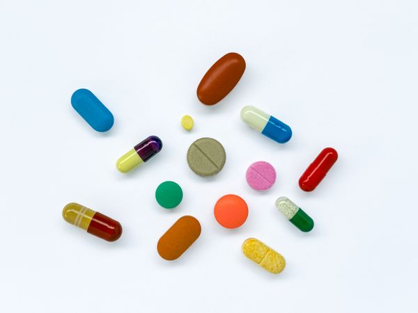 Colorful Capsules and Tablets on Neutral Background