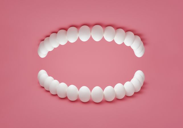Human denture concept with chicken eggs