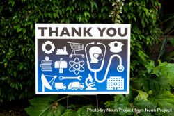 Close up of thank you yard sign for essential workers with icons during lockdown bYqZDb