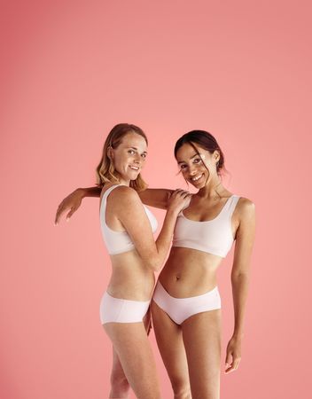 Two women with skin conditions standing next to each other