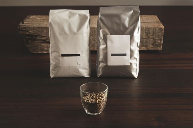 Bags of coffee beans and glass of beans