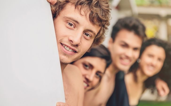 Group of young people in swimsuit having fun outdoors