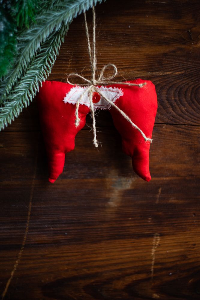Christmas card concept of angel wings on dark wooden table
