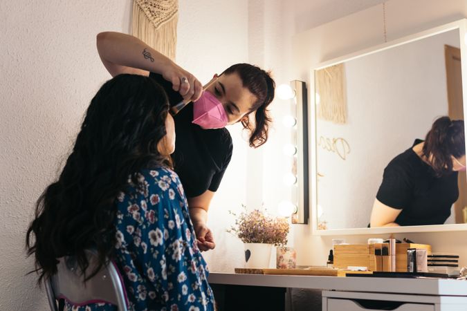 Bride being made up by a professional makeup artist