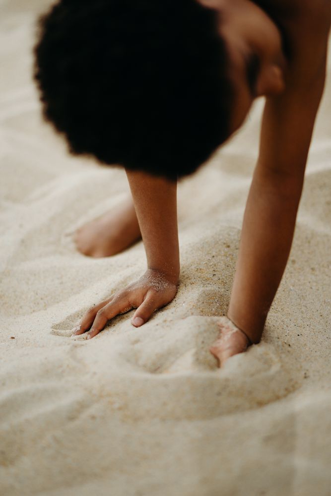 Black boy playing on beach