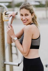 Sportswoman resting after workout in a sandy beach