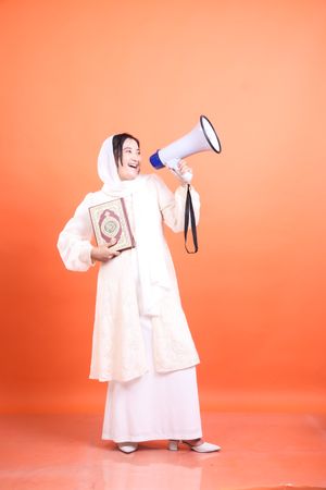 Energetic muslim woman with megaphone delivering an uplifting speech