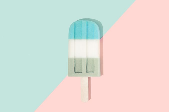 Ice cream popsicle in pastel pink on paper duotone background