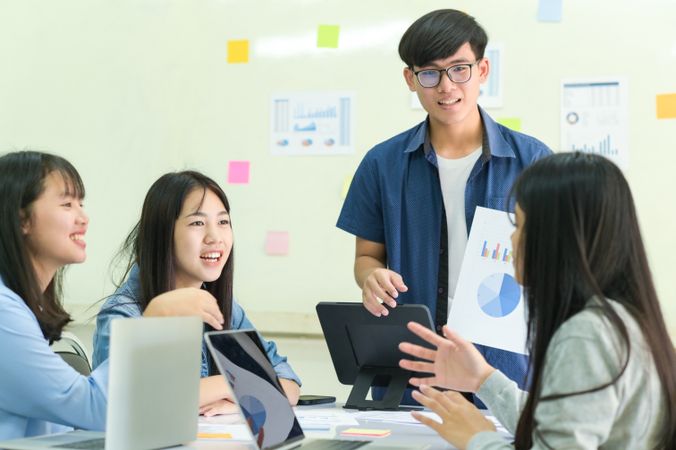 Group of young people brainstorming for work.