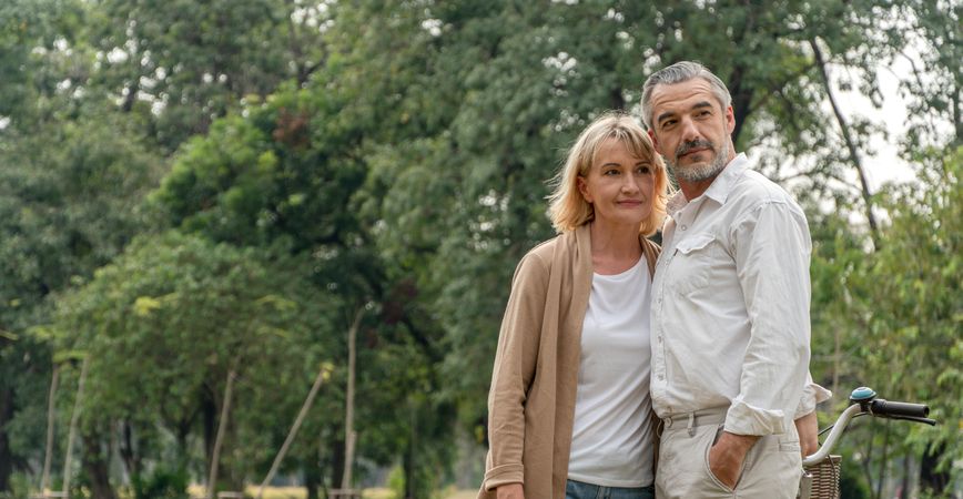 Mature man and woman standing in park