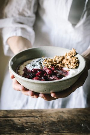 Faceless person with breakfast bowl with quinoa, rice and groats