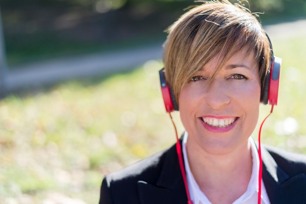 Portrait of female listening to music on red headphone