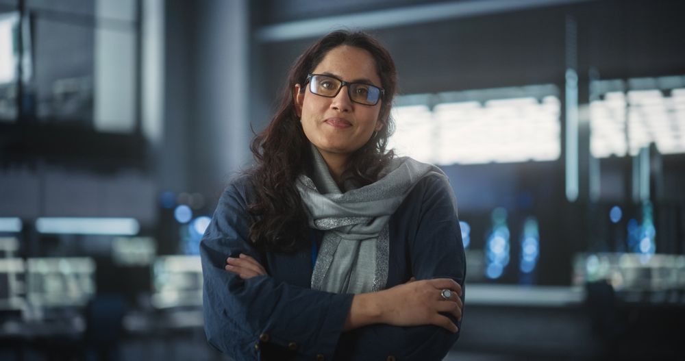 Portrait of Smiling IT Specialist Posing for Camera in Data Science Laboratory.