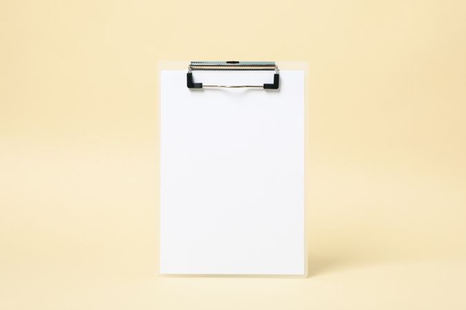 Empty clipboard on beige background, space for text
