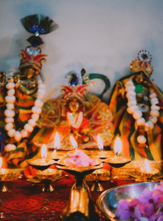 Diwali candles beside Hindu figurines
