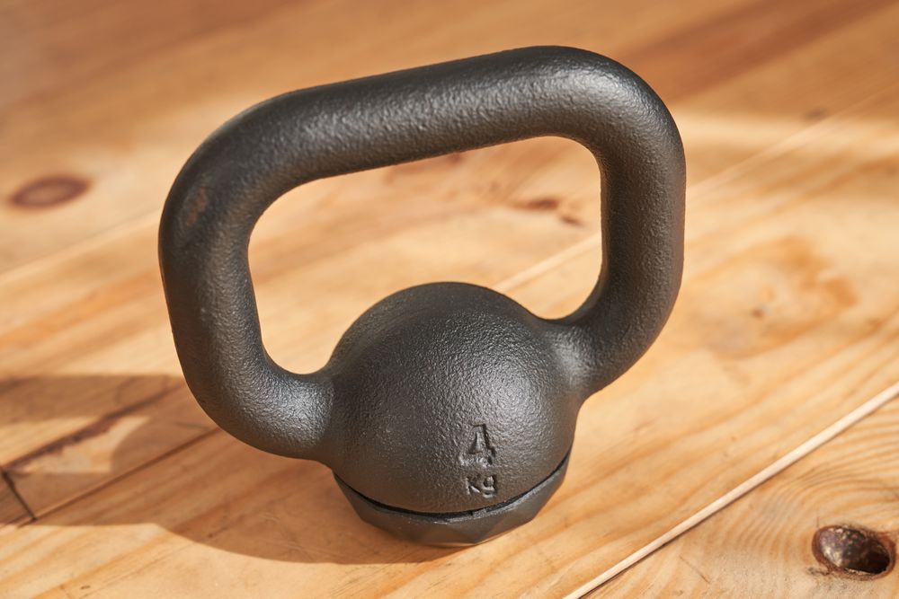 Metal kettlebell placed on parquet
