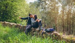 Couple kissing while making a break to do trekking