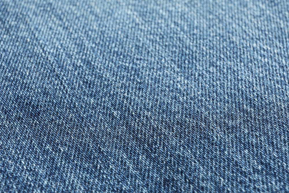 Texture of blue jeans as background, space for text