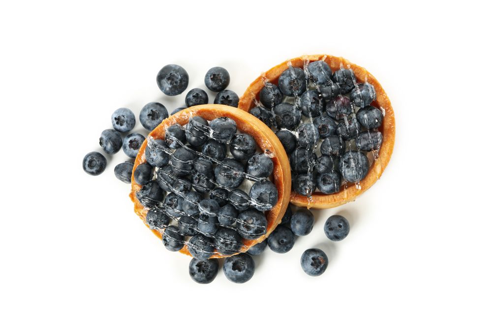 Tasty blueberry pies isolated on light background