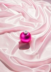 Pink Christmas ornament on pink fabric