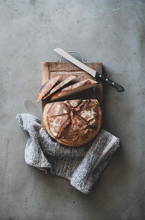 Freshly baked sourdough bread loaf, sliced, vertical composition