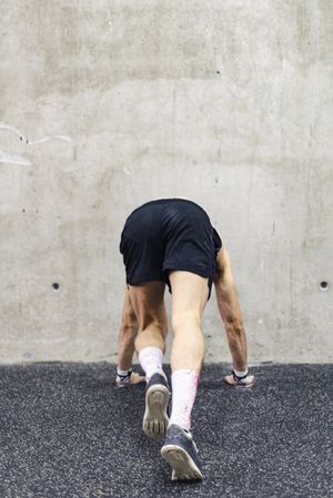 Man doing handstand in gym