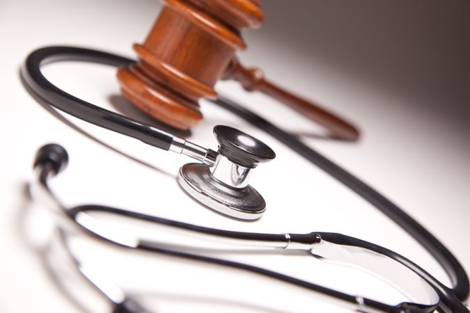 Gavel and Stethoscope on Gradated Background