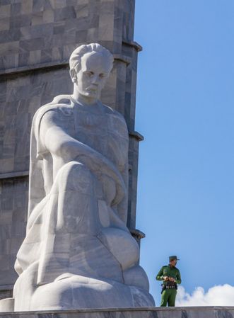 Havana, Cuba - November, 22 2012: Military man near huge statue