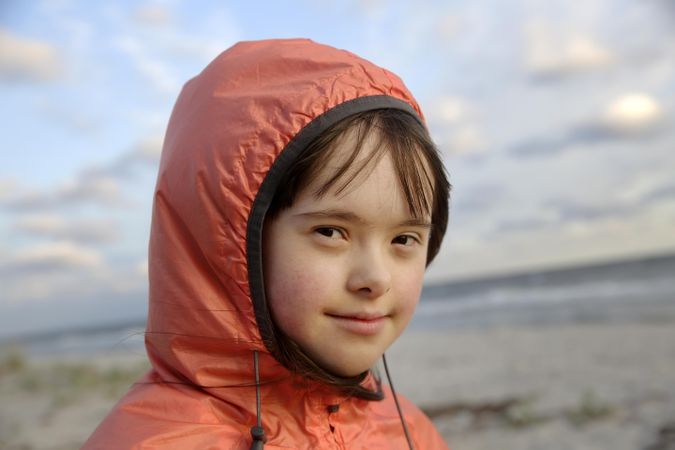 Close up of young girl wearing jacket at the beach