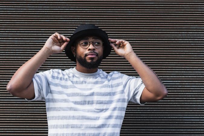 Black hipster man in hat looking away